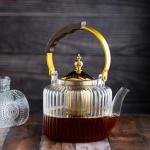 Luxury undulating glass teapot with gold accents and wooden handle