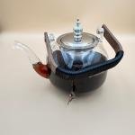 Elegant glass teapot with silver infuser and wooden handle